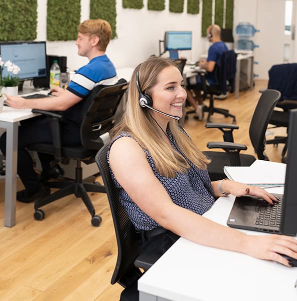 Photograph of QCF staff members taking phone calls